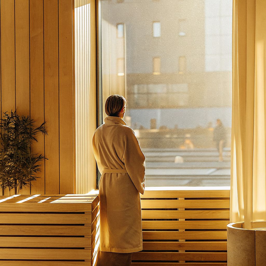 Person pausing by a window, illustrating the space between stimulus and response