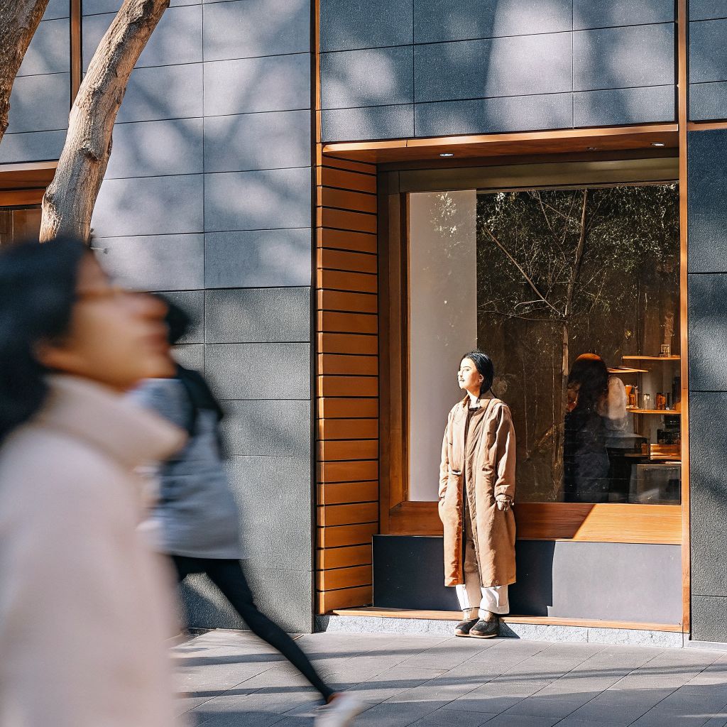 Person pausing to breathe in a busy street, inner world outer world awareness