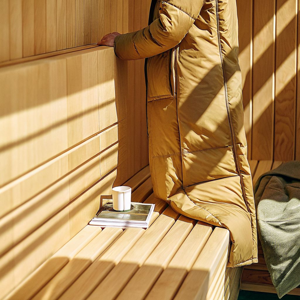 person gently setting down a heavy coat