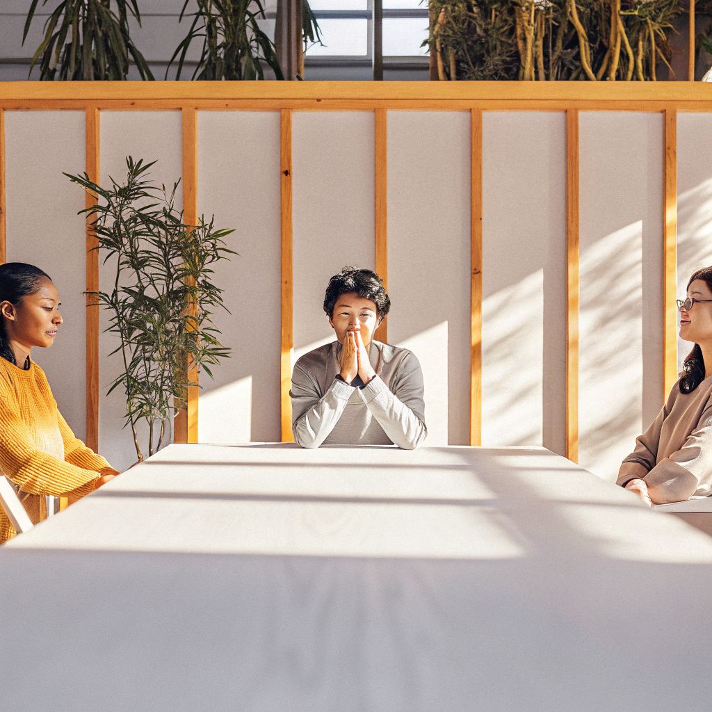 person pausing before responding in a meeting