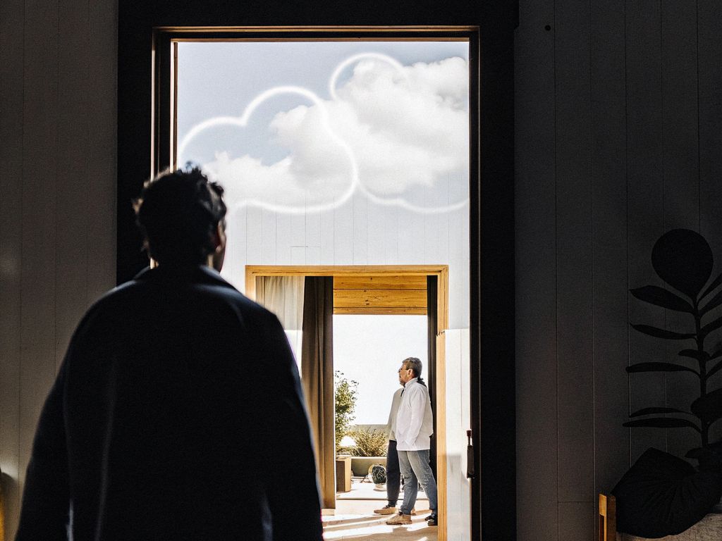 silhouetted person walking into group, thought clouds above