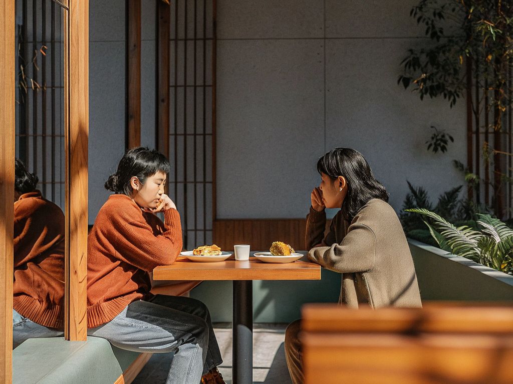 Two friends comparing similar choices with subtle differences