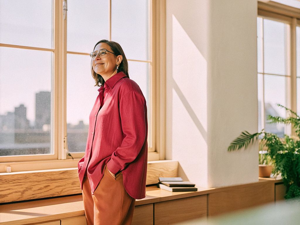 confident leader pausing at office window