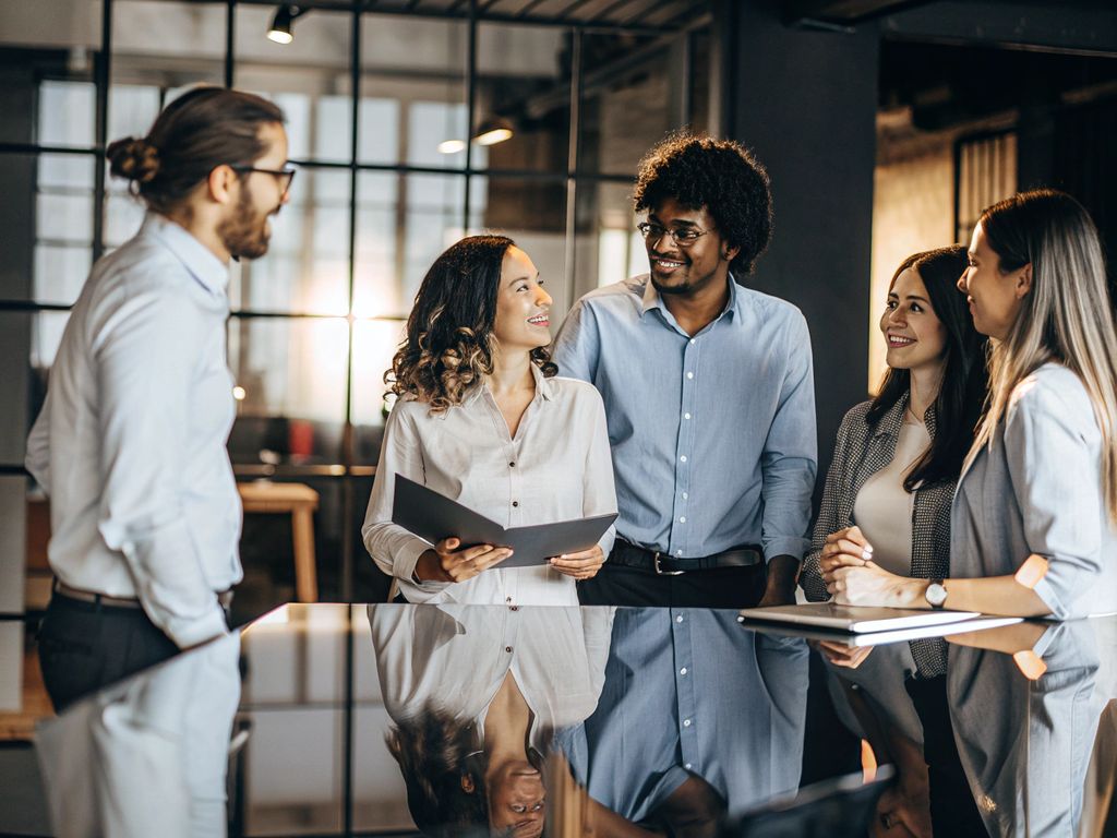 diverse modern team pausing for reflective conversation