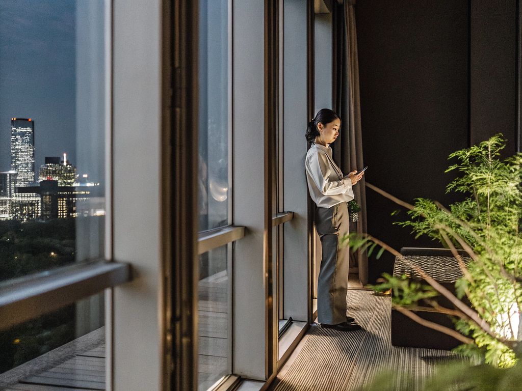person pausing at night in city high-rise