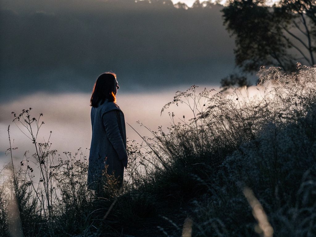 woman pausing to reflect at sunrise