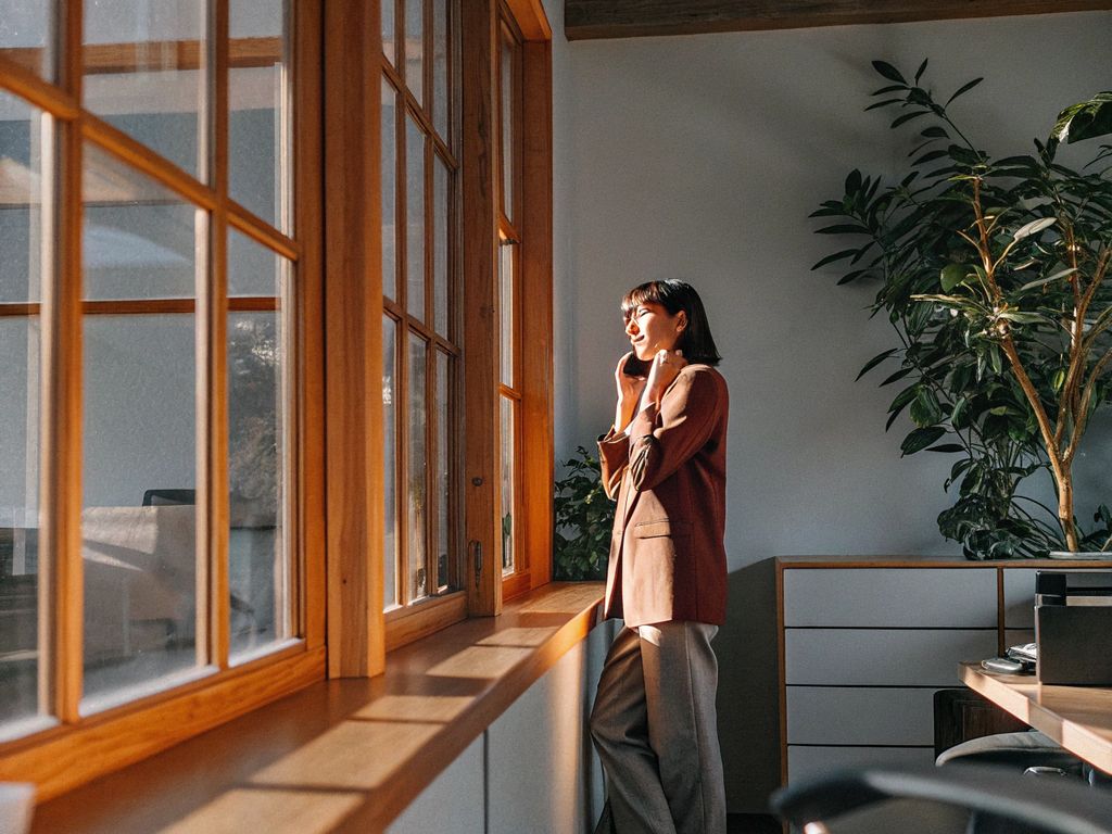 ambitious person pausing in a bright, open office