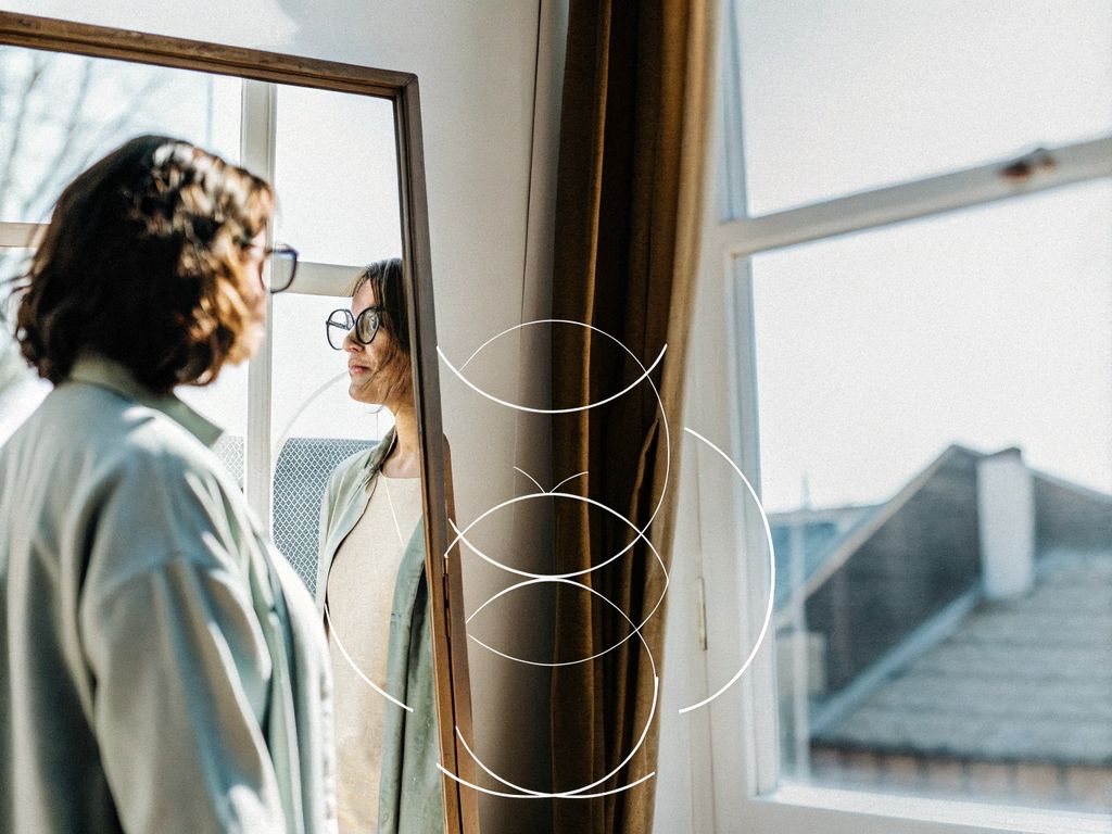 person looking into a mirror, reflection shows patterns overlaying their expression