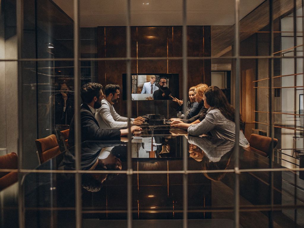 team meeting showing mixed energy with disengaged and engaged members