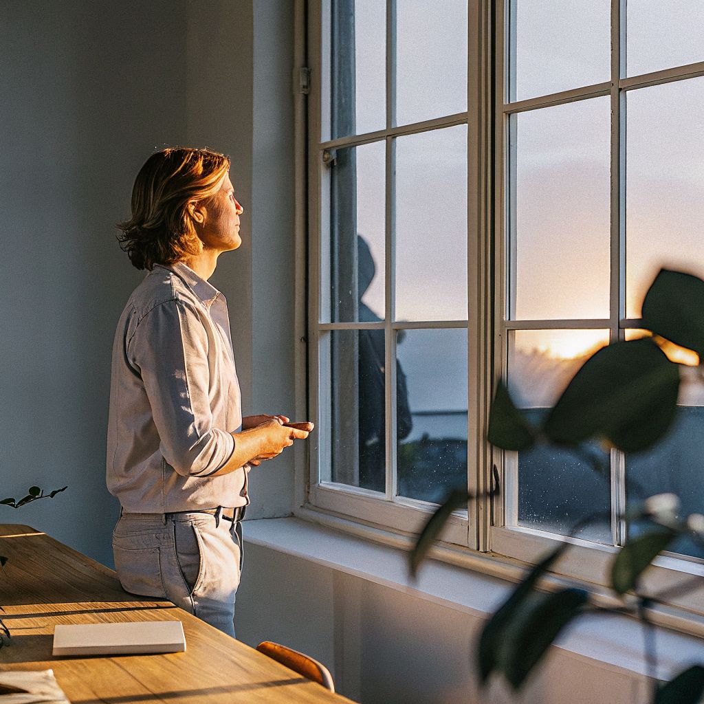 leader looking out a window in a quiet office