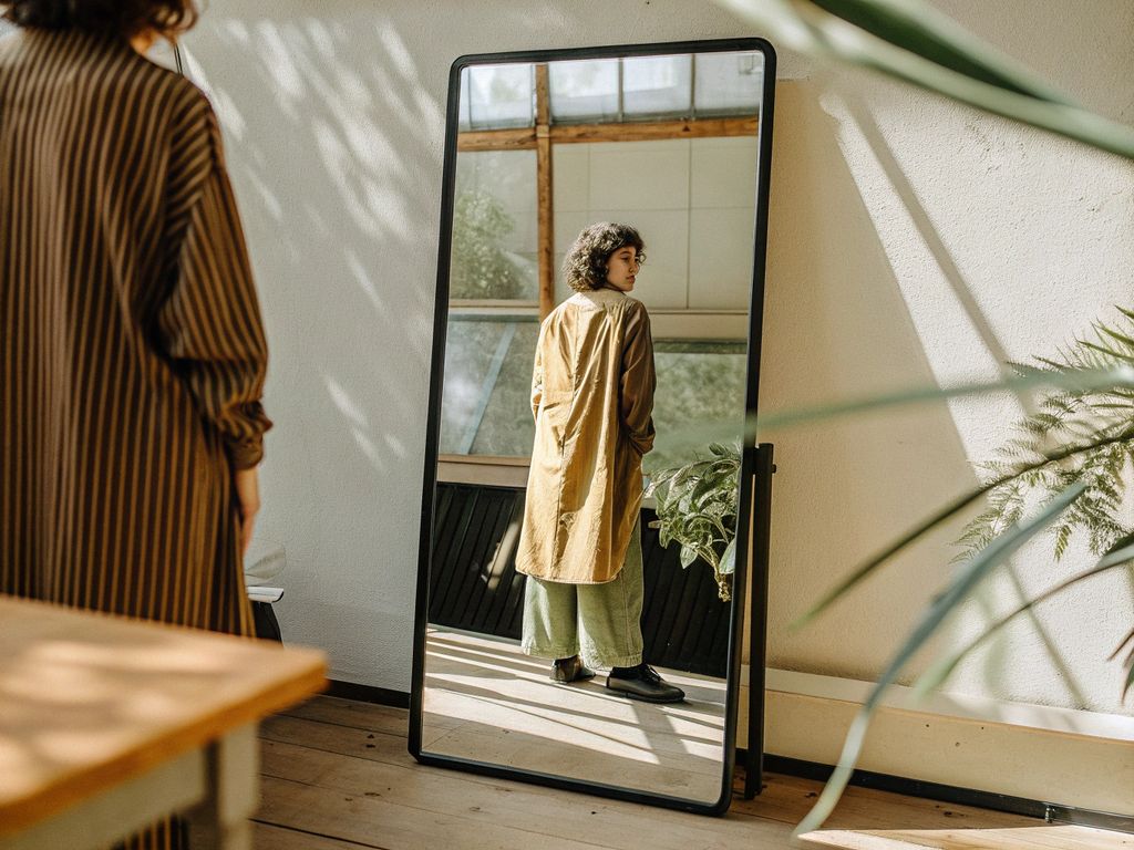 reflection in mirror symbolizing inner beliefs shaping outer world