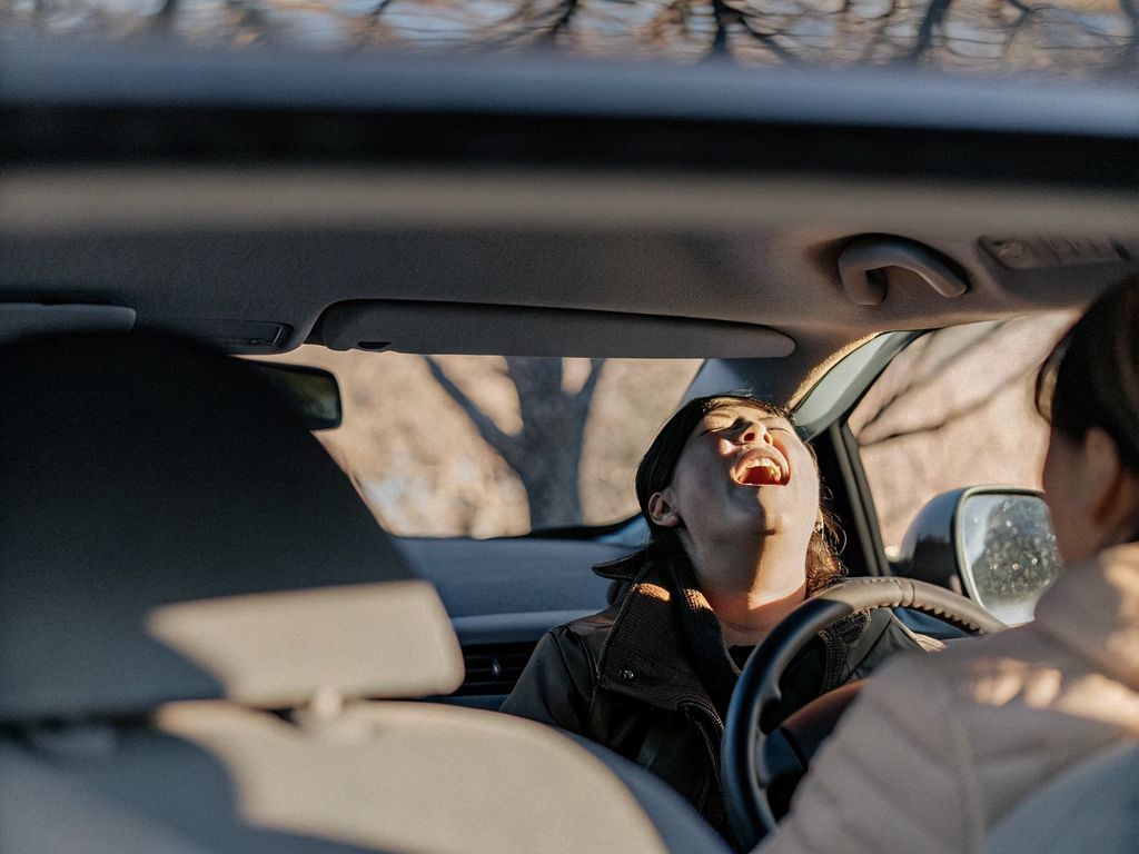 person singing in car, sunlight streaming in