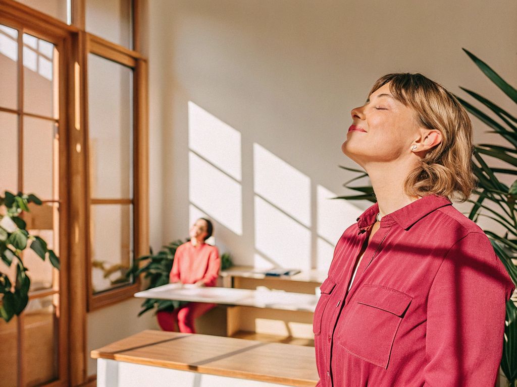 busy leader pauses at window