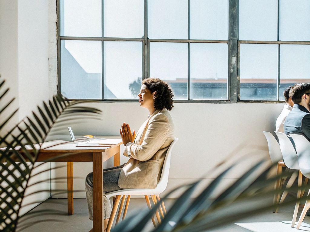 Person pausing and reflecting in an office