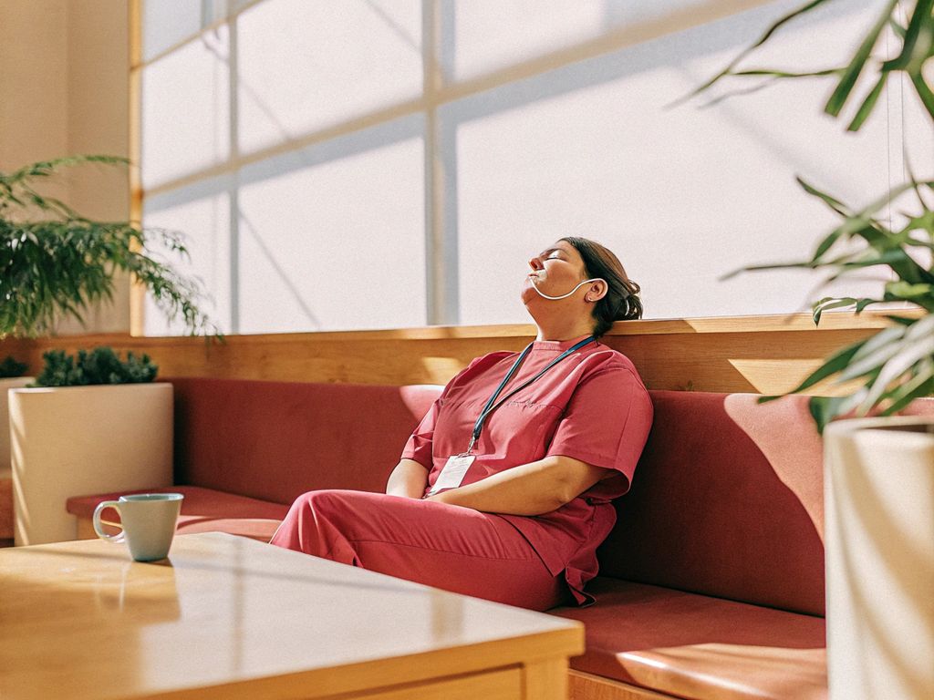 healthcare worker pausing for mindful breath in a break room