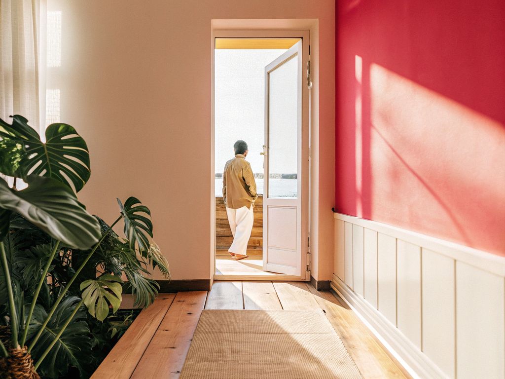 shadowy hallway with a single door slightly open