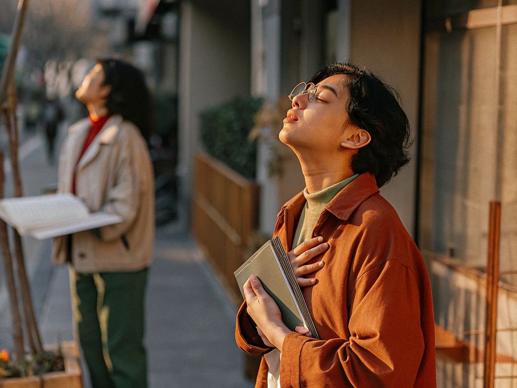 person pausing in thought, busy urban setting