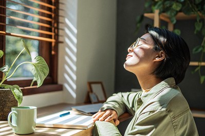 Person doing a posture reset and six-second breath at a desk