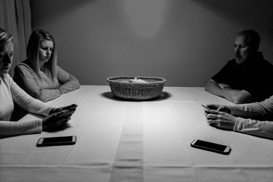 Family dinner with phones in a basket