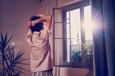 Person practicing self-havening in morning light