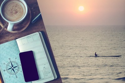 Sunrise over open ocean with a lone rower