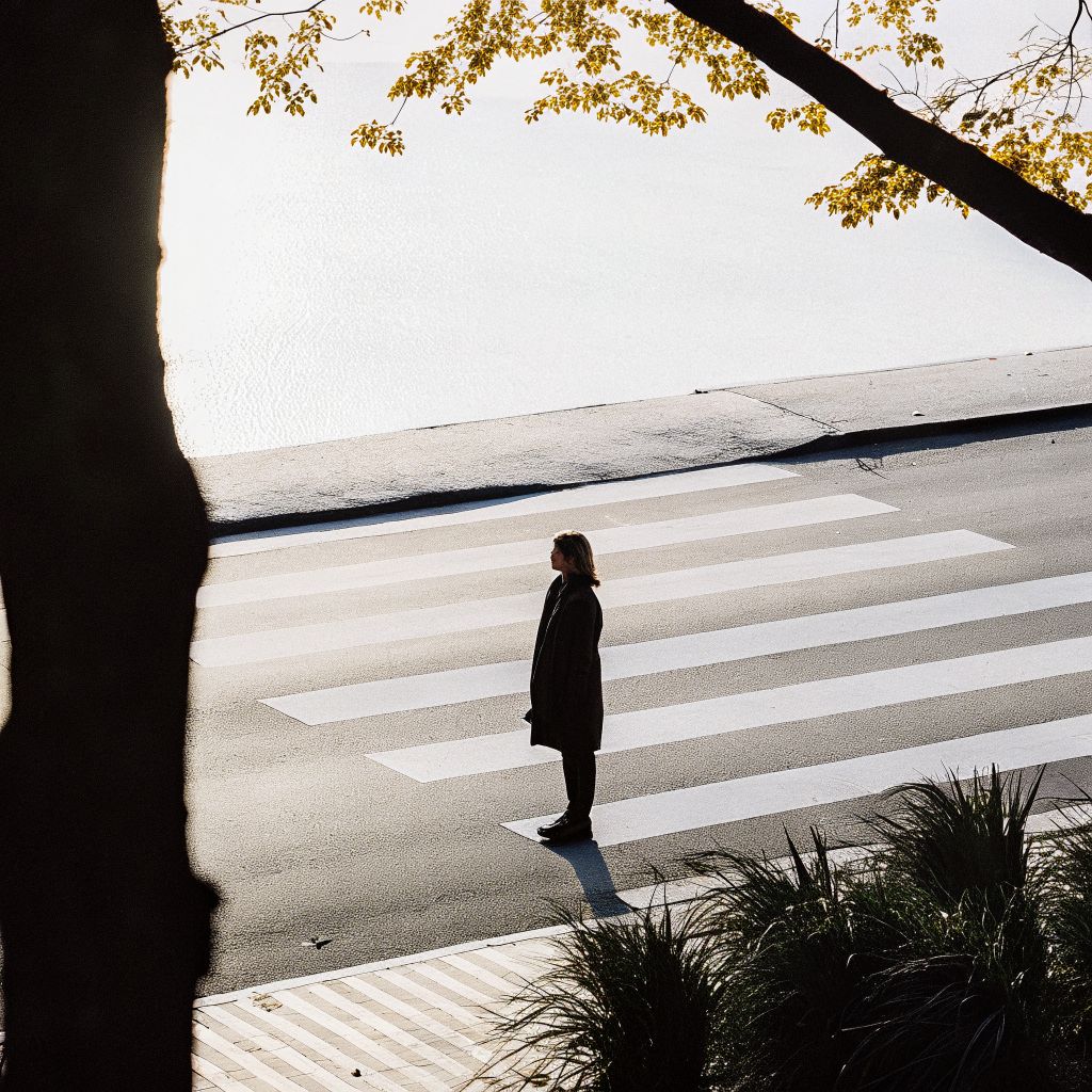 Person at a crosswalk reflecting on inner alignment and next steps