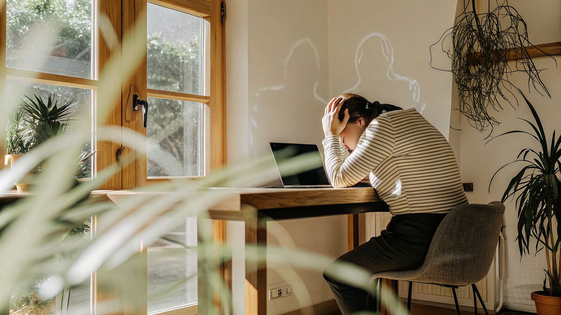 Person at a desk with overlayed internal rules illustrating burnout identity patterns