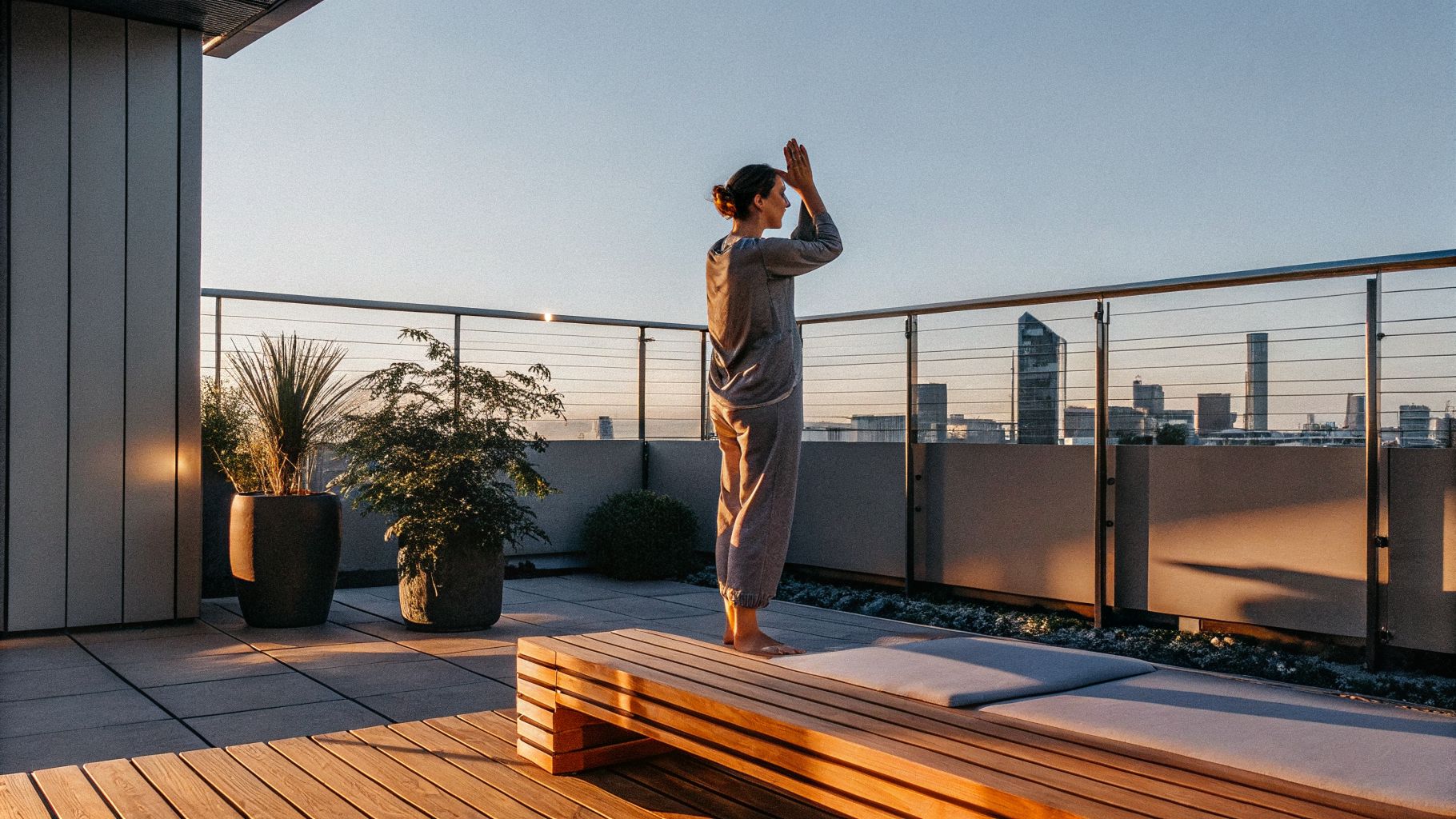 Awareness and change: person pausing at sunrise with a city in the background